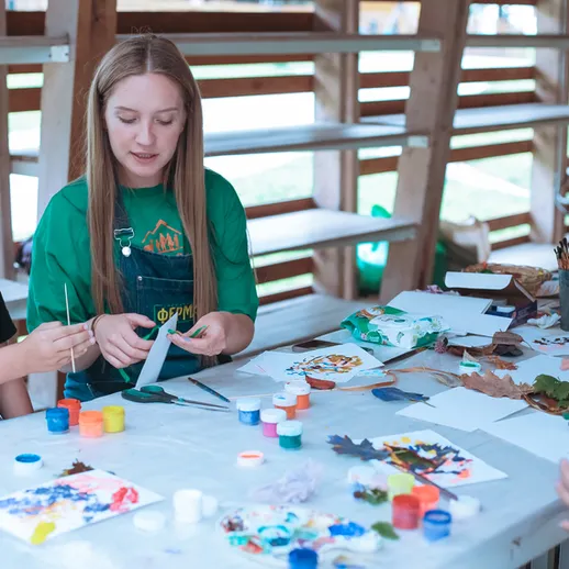 Дети и взрослые занимаются творчеством на мастер-классе по рисованию в уютном помещении