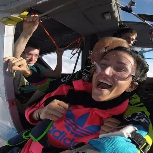 Прыжок с парашютом над облаками с группой инструкторов в ясный день