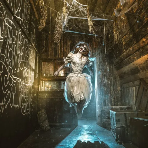 Загадочная кукла в старом заброшенном доме с сетью паутины и размытым светом