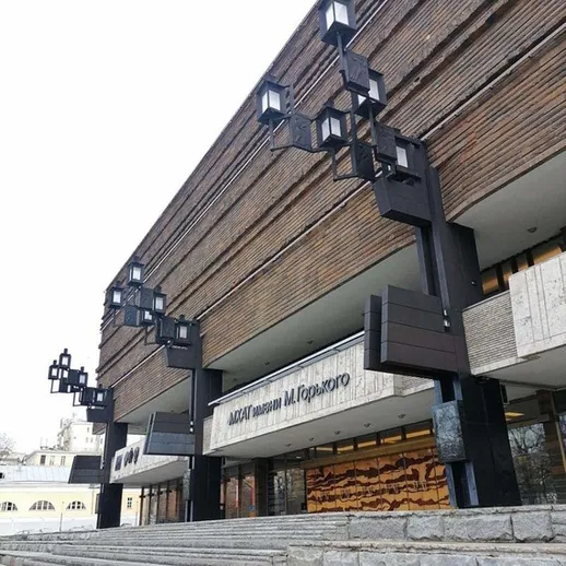 Здание Театра Маяковского в Москве с интересной архитектурой и светильниками в зимний день