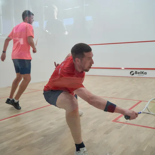 Игроки в сквош на корте в середине дня, активно соревнуясь в Москве