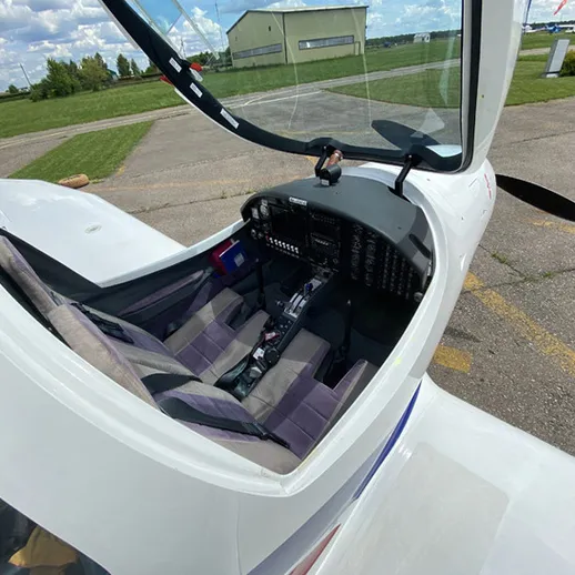 Кабина небольшого самолета на аэродроме, готовящегося к полету, под ясным небом в летнее время