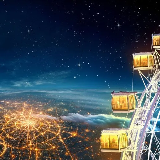 Колесо обозрения над городом ночью с яркими огнями