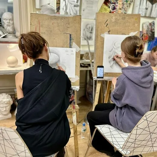 Студенты занимаются рисованием в художественной студии, создавая графические работы с натуры в вечерах