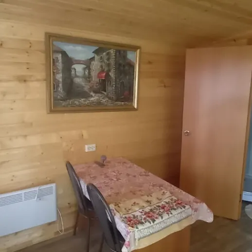 Уютная деревянная комната с столом и шкафом на фоне художественной картины