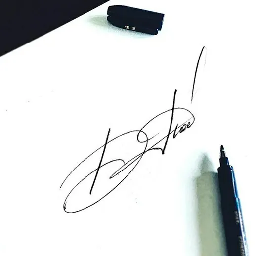 Подпись на белом листе бумаги с черной ручкой и ластиком