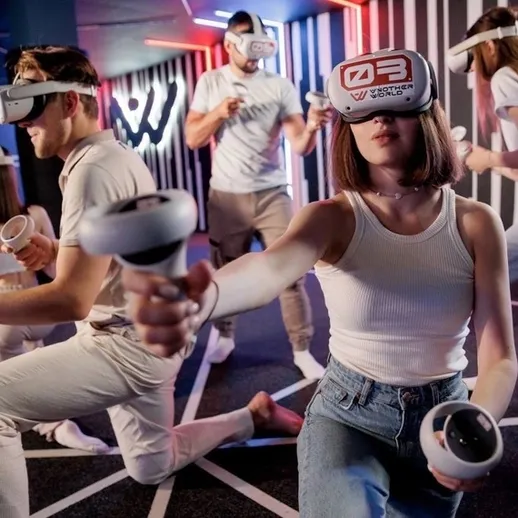 Играющие в виртуальной реальности молодые люди в центре развлечений, находящиеся в процессе игры в 2023 году