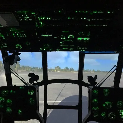 Кабина вертолета с ночной подсветкой на аэродроме на фоне леса в ясный день