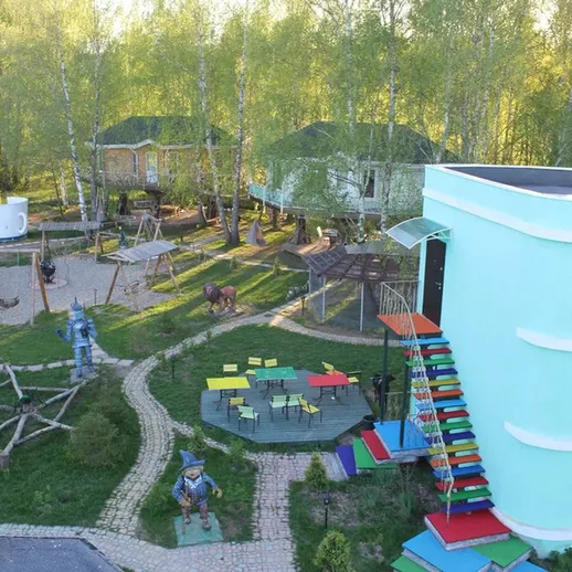 Необычная детская площадка с причудливыми игровыми элементами в живописном парке