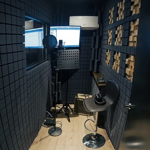 Уютная звукозаписывающая студия с микрофоном и компьютером, идеально подходящая для записи вокала