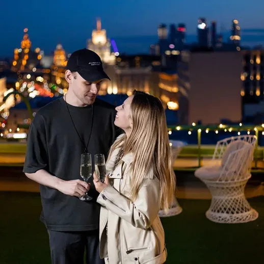 Романтический вечер на крыше с видом на городской пейзаж в вечернее время